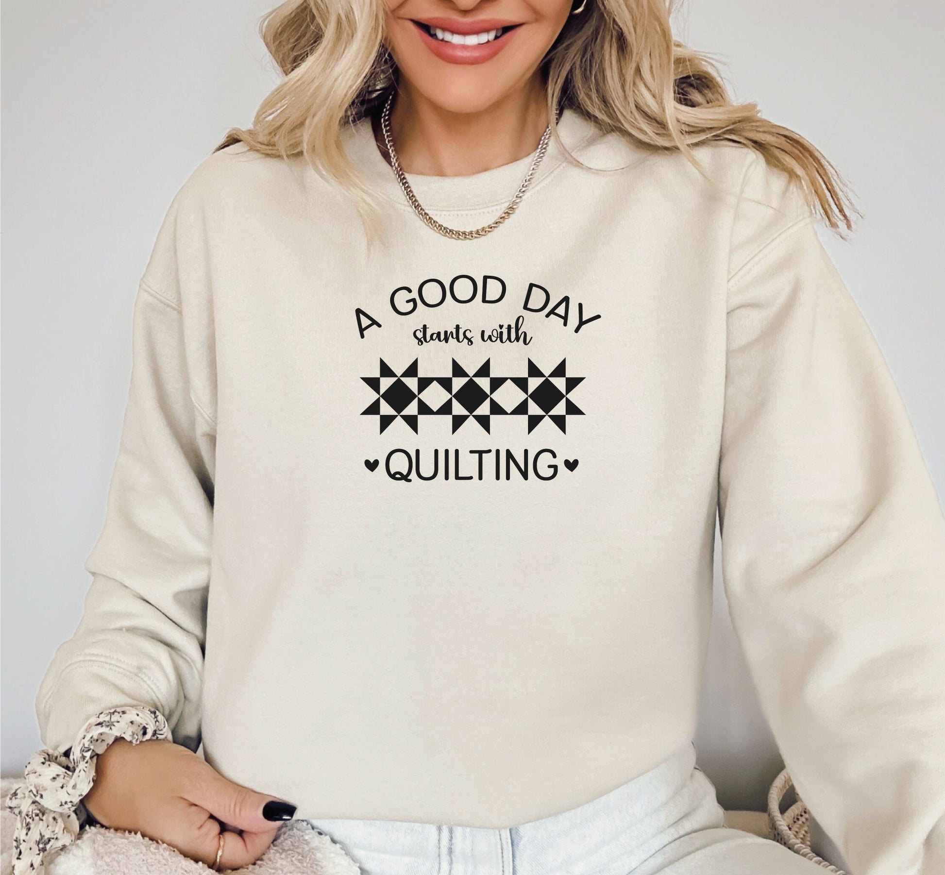 A Good Day Starts With Quilting Sweatshirt. Unisex sizing. Sand sweatshirt with fun black text.