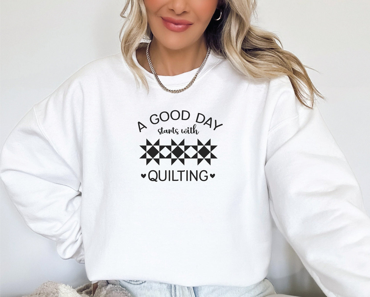 A Good Day Starts With Quilting Sweatshirt. Unisex sizing. White sweatshirt with fun black text.