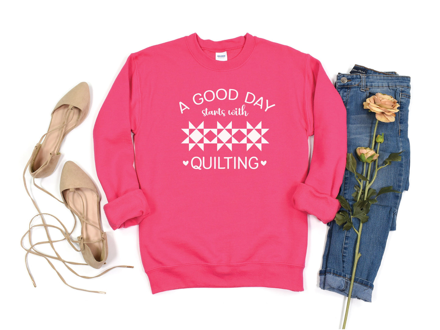 A Good Day Starts With Quilting Sweatshirt. Unisex sizing. Pink (Heliconia) sweatshirt with fun white text.